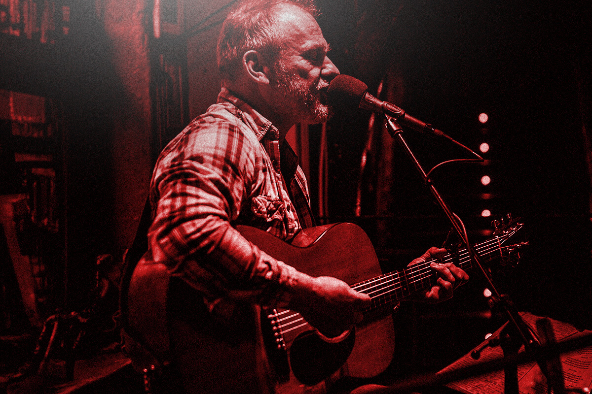 Harbinger Pro Audio Man Playing Acoustic Guitar