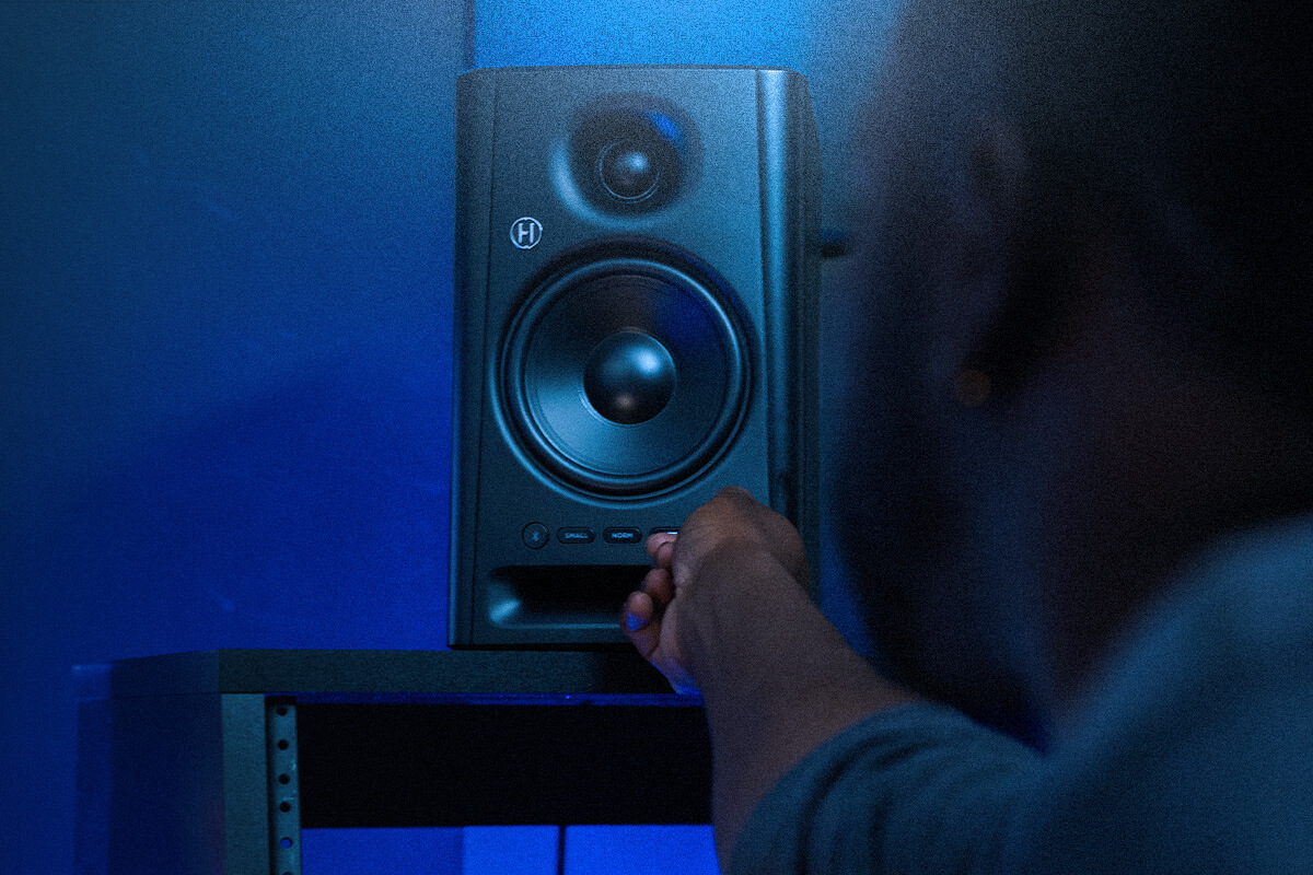 Harbinger Pro Audio SM505 Man Adjusting Volume On Studio Monitor Mobile