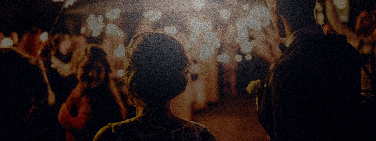 Bride and groom walking through sparklers