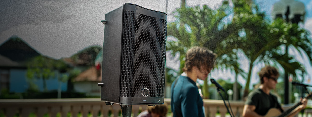 One Harbinger Vari Live V2400 Speaker on a pole at an outdoor concert