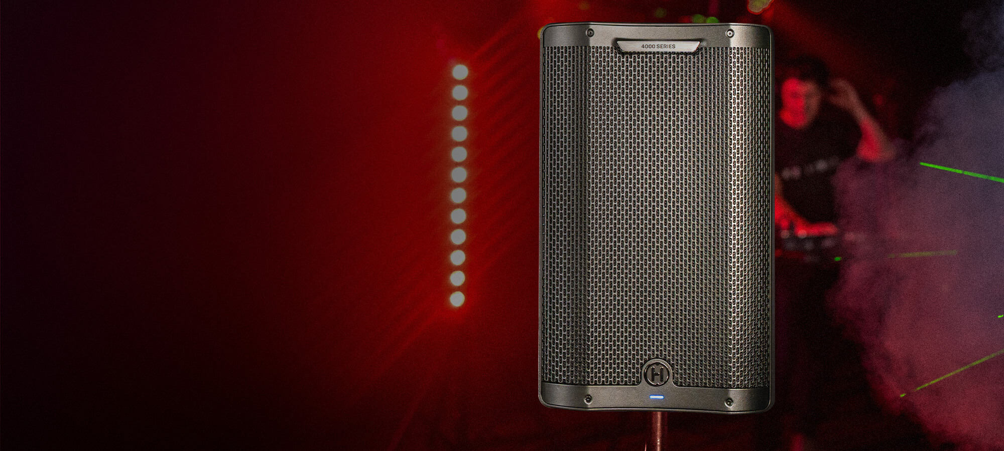 Harbinger Vari Live 3400 Series speaker with a dj in the background